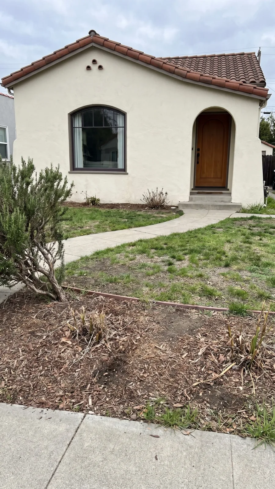 Spanish-style front yard before a Gardenful garden design